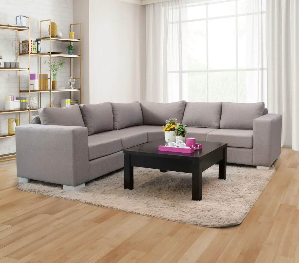 Grey Sofa Living Room Ideas Featuring an L-Shaped Grey Sectional On a Beige Shag Rug, Black Coffee Table, and Gold Shelving