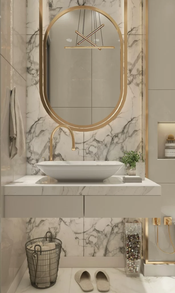 Mid Century Modern Bathroom Ideas Combining an Oval Gold Mirror, Marble Countertop, and Brass Faucet