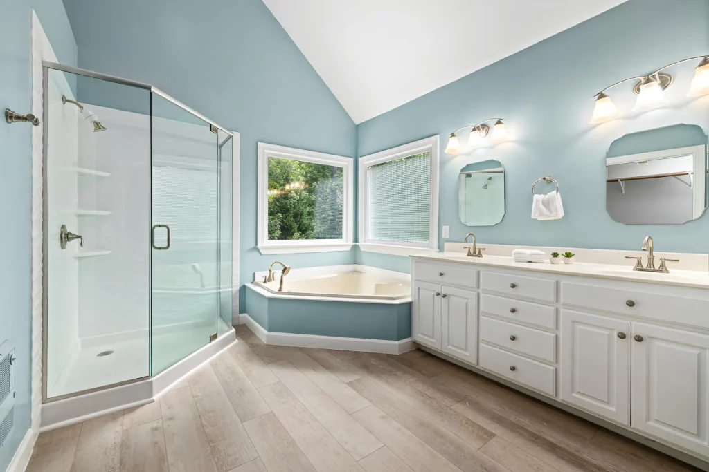 Mid Century Modern Bathroom Ideas Featuring Curved Wall Sconces and Blue Walls