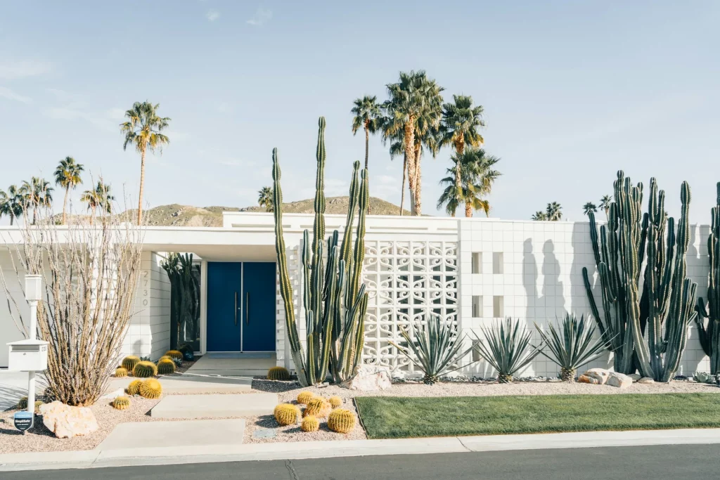 Mid Century Modern Exterior Features A Flat Roofline & White Breeze Block Facade