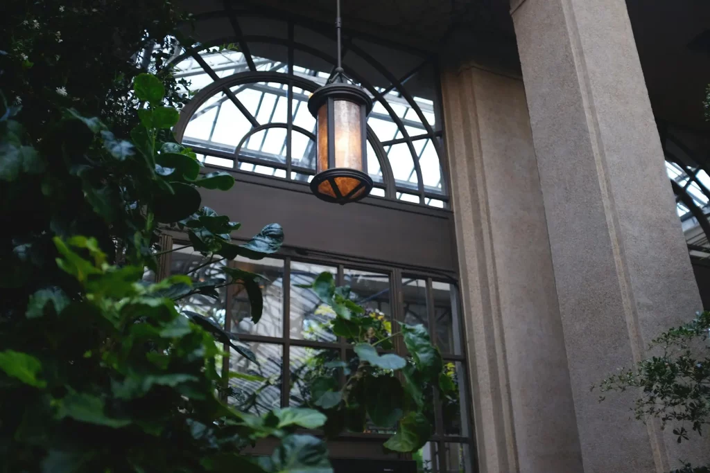 Mid Century Modern Exterior Light Fixture Hanging Under Arched Windows