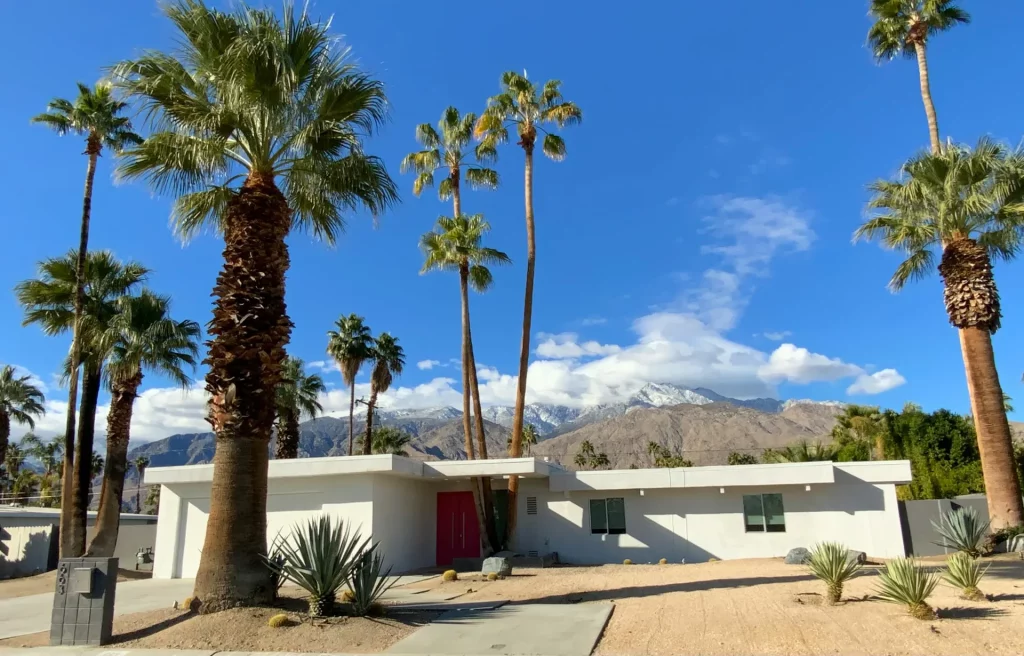 Mid Century Modern Exterior Ranch Home with Flat Roof, Red Front Door, and Desert Landscaping