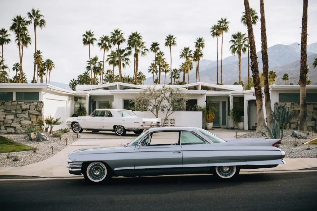 Mid Century Modern Exterior with Butterfly Rooflines and Horizontal Garage Doors