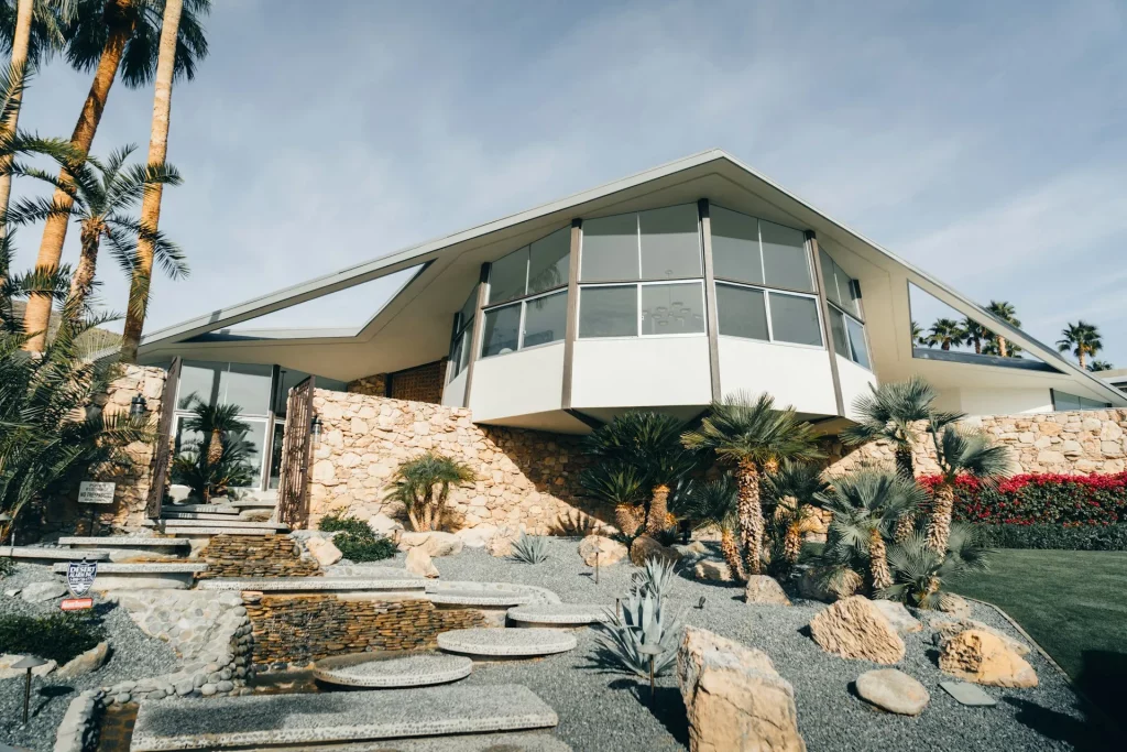 Mid Century Modern House Exterior with Angular Roofline and Large Glass Windows