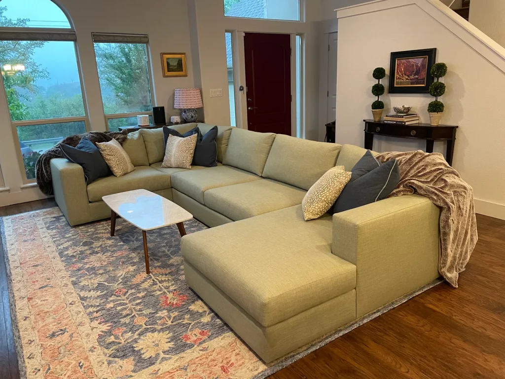 Spacious Living Room Featuring The Most Comfortable Sectional Sofa With Chaise In Light Green Fabric