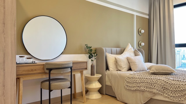 A cozy bedroom with a vanity and a bed