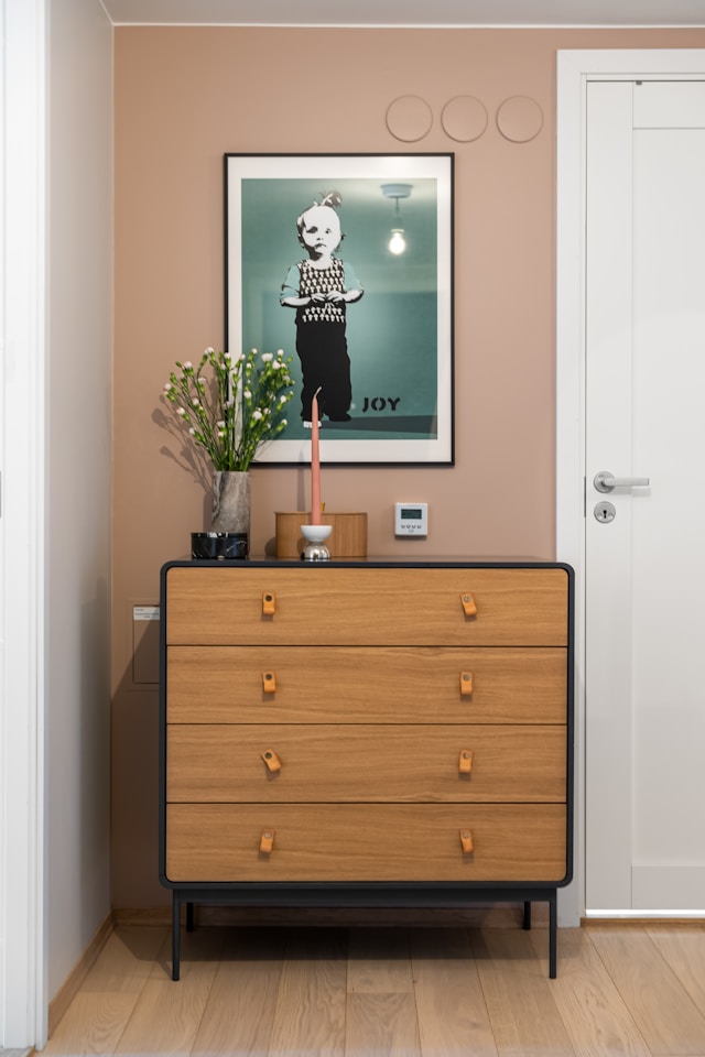 A room with a dresser and a picture on the wall