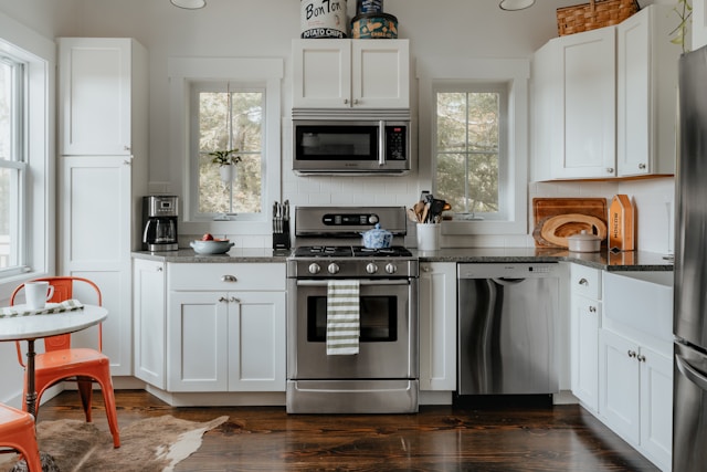 Minimalist kitchen with white cabinets, open shelves and warm neutral tones