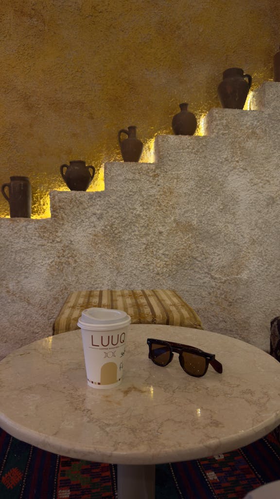 Sunglasses and a Disposable Cup on a Marble Coffee Table