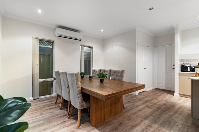 A large dining room with a wooden table and chairs
