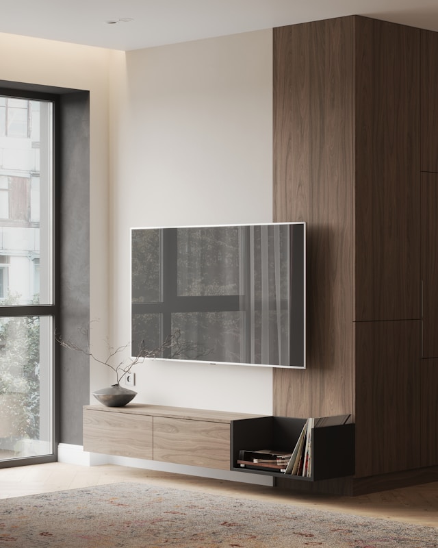 A living room with a television stand on a wall