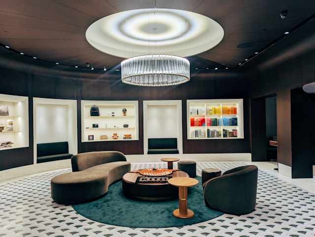 A living room with curved couch and circular chairs