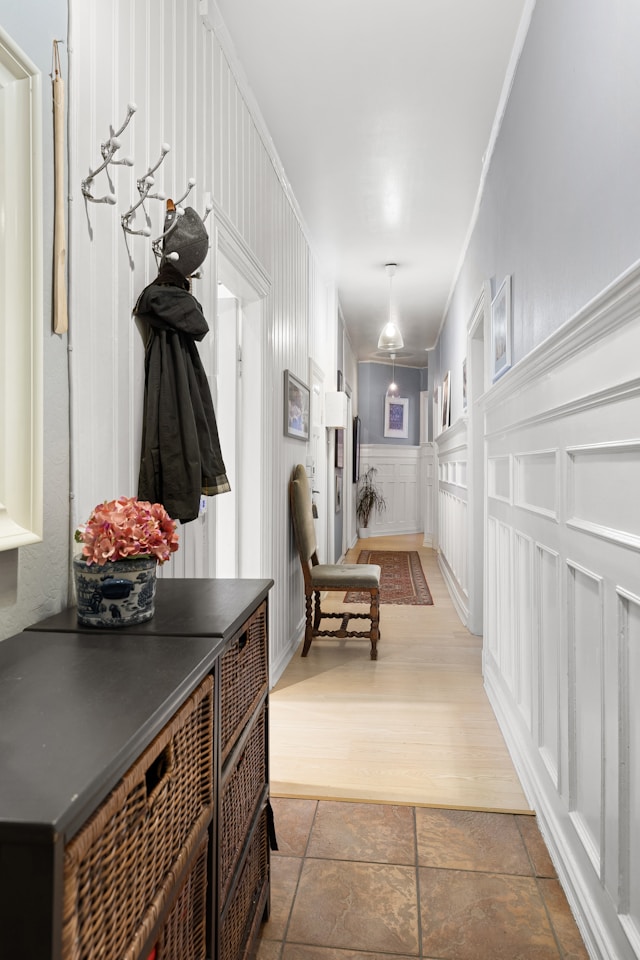 A long hallway with white walls and storage furniture