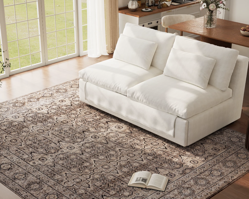 A stylish white loveseat in a bright living room, serving as the compact base for the best sleeper sofa before conversion.