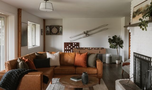 Cozy living room with a brown sectional sofa, fireplace and TV