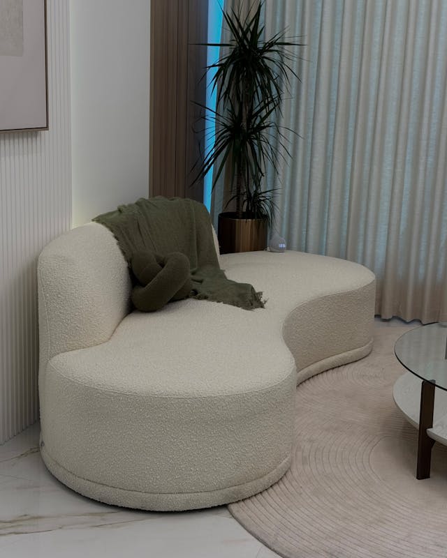 Cozy modern room with curved sofa and plants