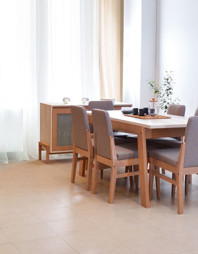 Dining table with chairs in a bright, modern room.