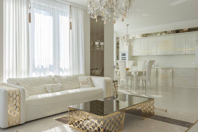 Elegant living room with gold accents and chandelier