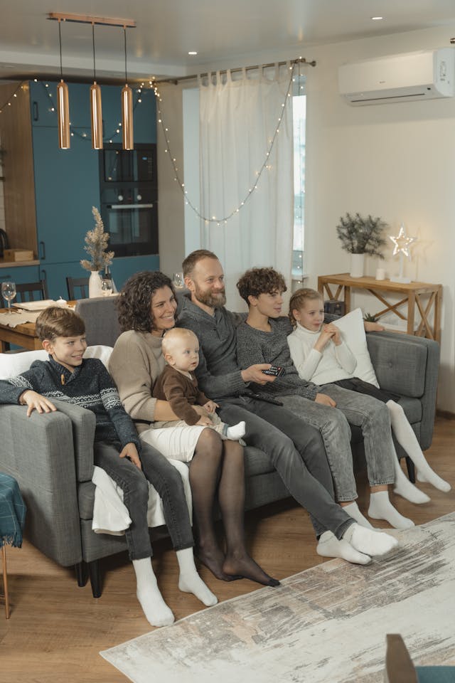 Family enjoying movie night on a sofa, showing real-life modular use