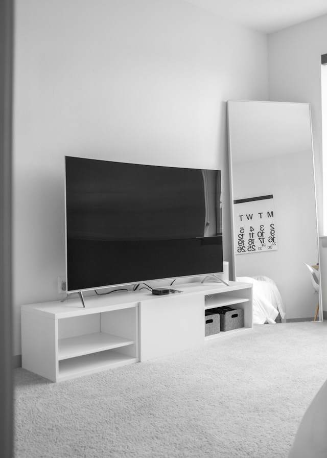 Gray TV on white modern TV stand