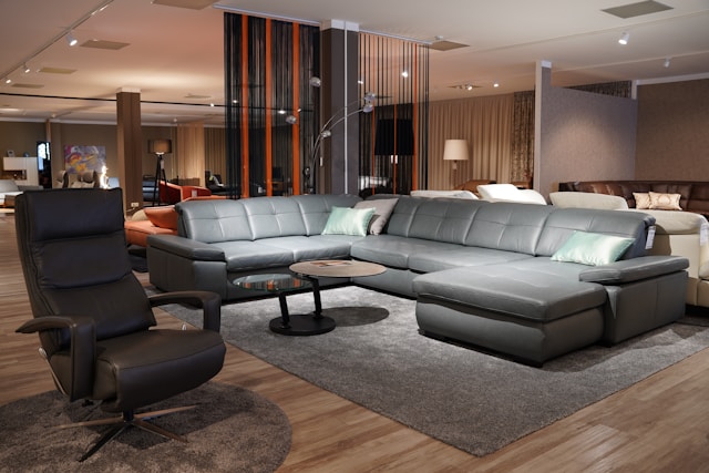 Large gray leather sectional sofa and recliner in a living room