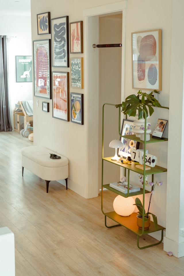Long hallway styled with wall art, a narrow bench and a floating shelf that doubles as a small entryway table.