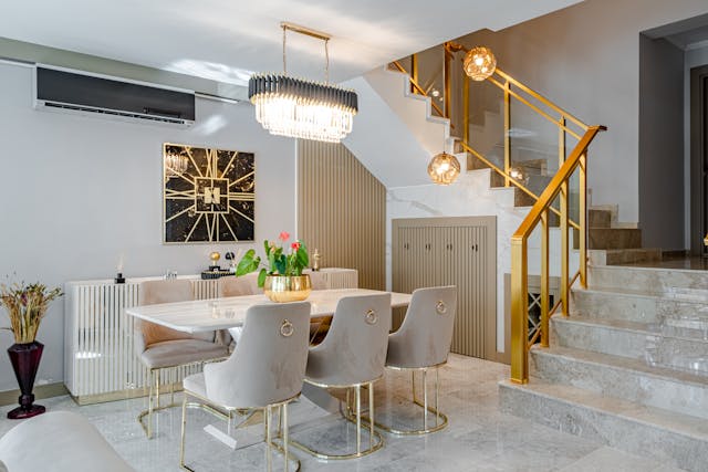 Luxury dining room with a marble dining table, gold accents, and statement pendant lighting