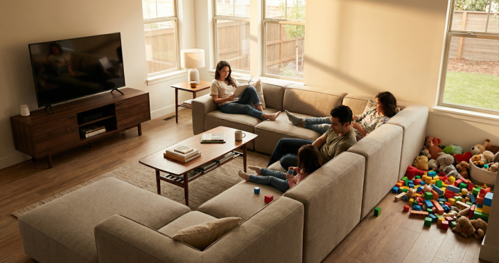 Medium-sized family living room with an L-shaped modular sofa, coffee table, and toys, showing a practical everyday seating layout