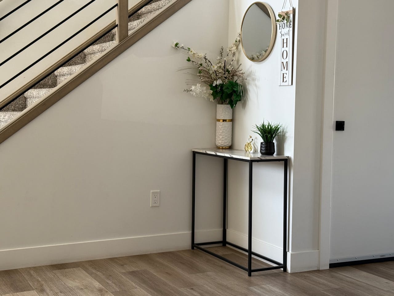 Minimalist entryway with console and staircase
