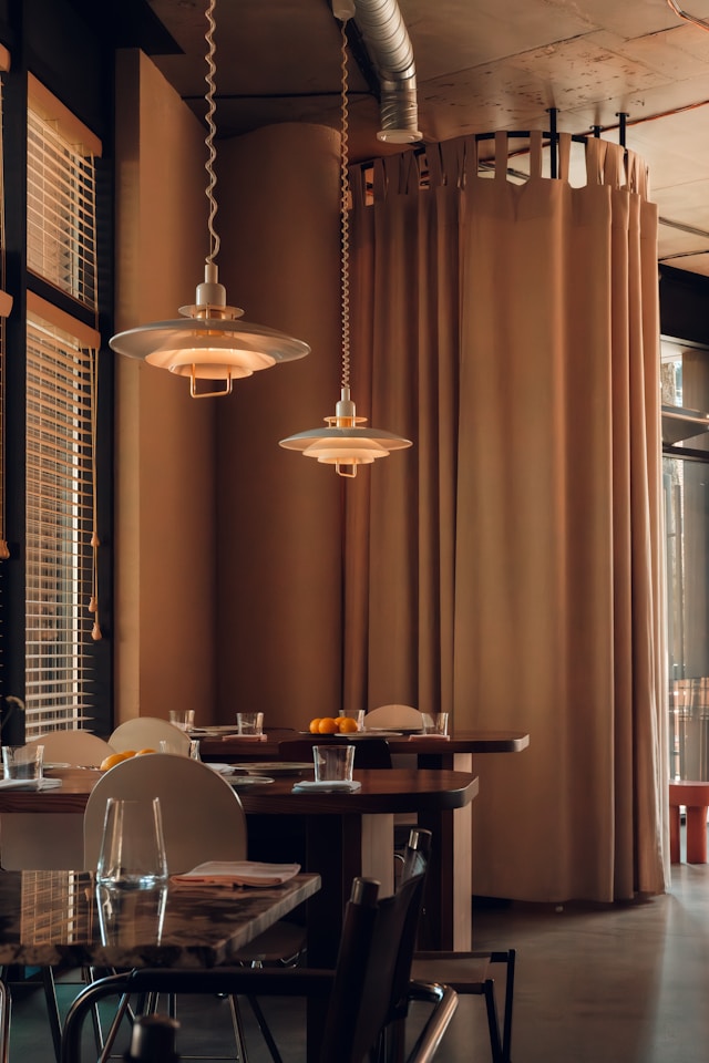 Modern dining area with pendant lights and chairs