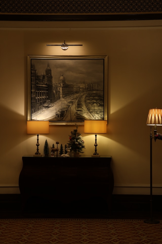 Slim console with a vase and books against a light wall, perfect for illustrating minimalist wall decor.