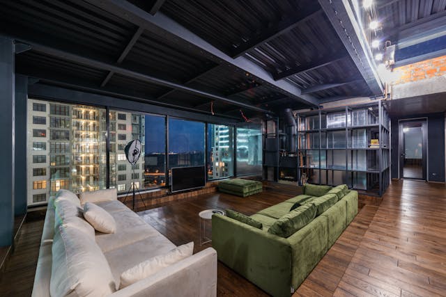 Spacious modern living room with two large sofas and floor-to-ceiling windows