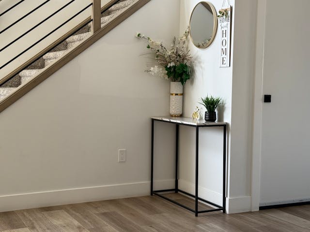 Stylish home entryway featuring a minimalist console table and decorative items.