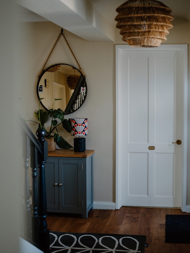 a round mirror and an entryway table