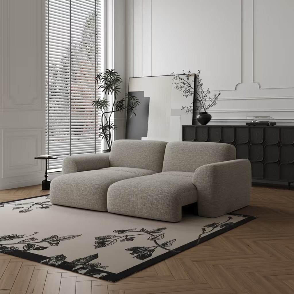 Gray modular sleeper loveseat with extended lounge seats and wide arms in a modern living room.