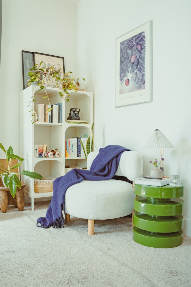 reading nook with upholstered armchair bookshelf and warm lighting