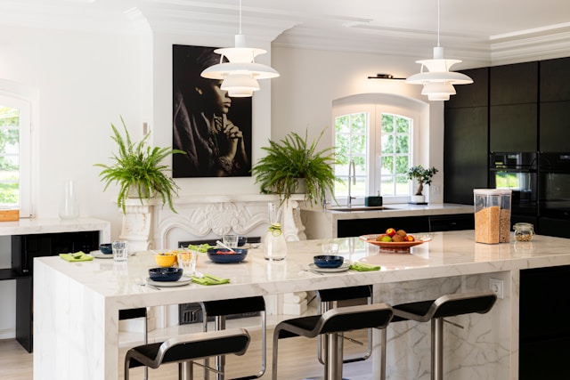 large kitchen island with multiple modern bar stools set for casual dining