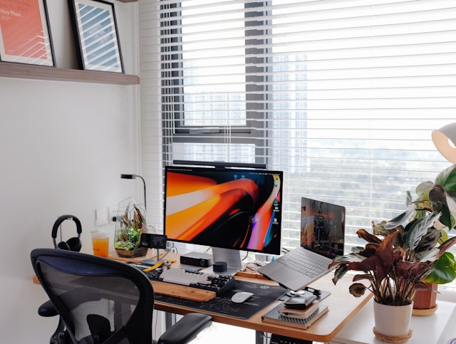 modern home office with organized desk, monitor and window light