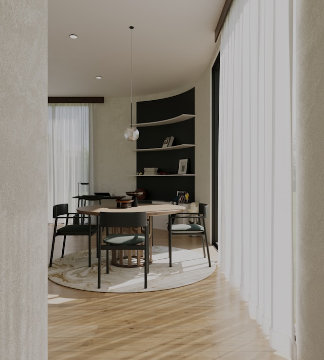 modern round dining table in a bright open-plan dining room