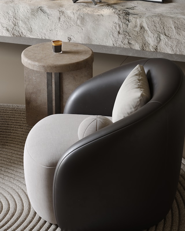 modern accent chair with neutral pillow next to a small side table in a minimalist living room