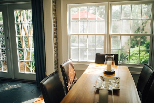 wooden dining table and black leather chairs