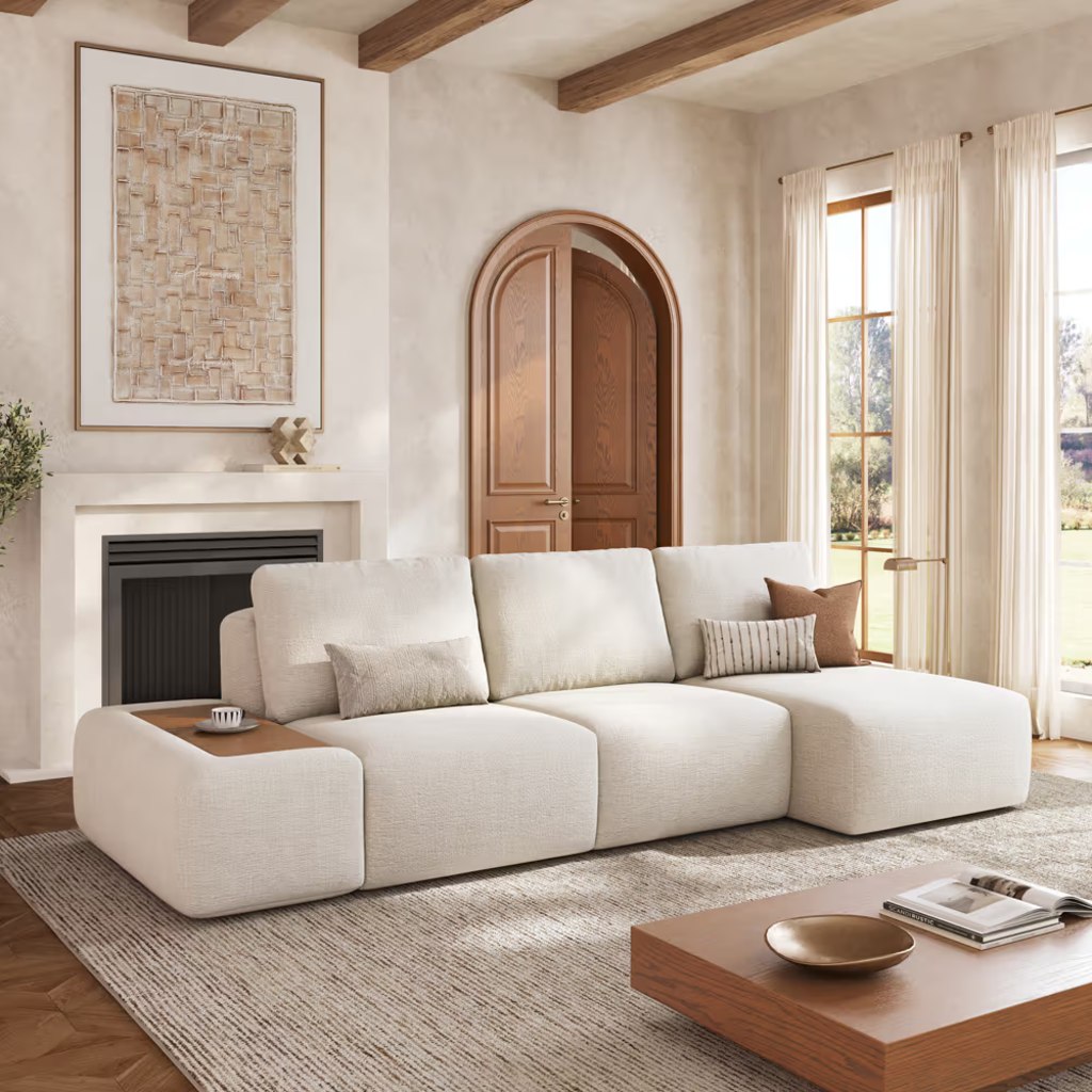 Cream modular sectional sofa with a movable wood-topped arm module and chaise in a warm modern living room.