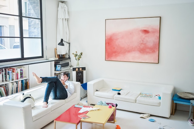 Cozy man reclining on a white sofa in a stylish apartment