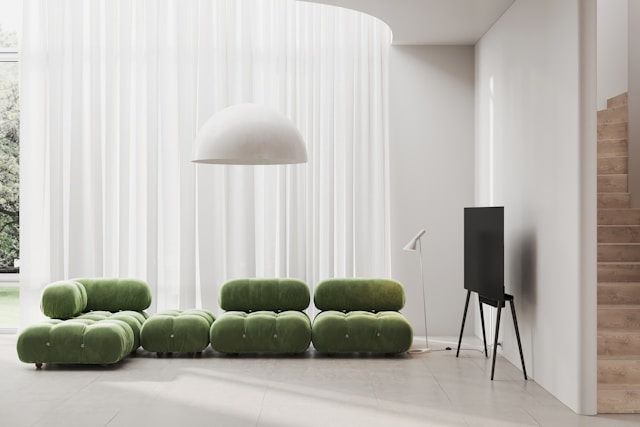 Green sectional sofa in a modern living room