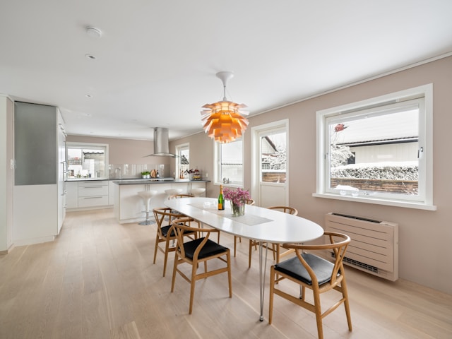 Modern oval dining table in bright open kitchen