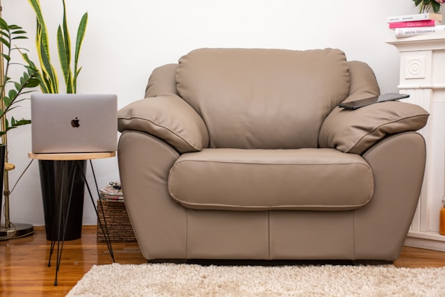 a brown leather chair sitting in a living room