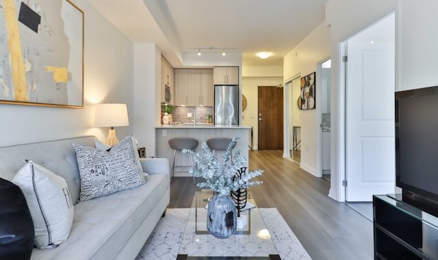 a living room with a couch and a glass coffee table