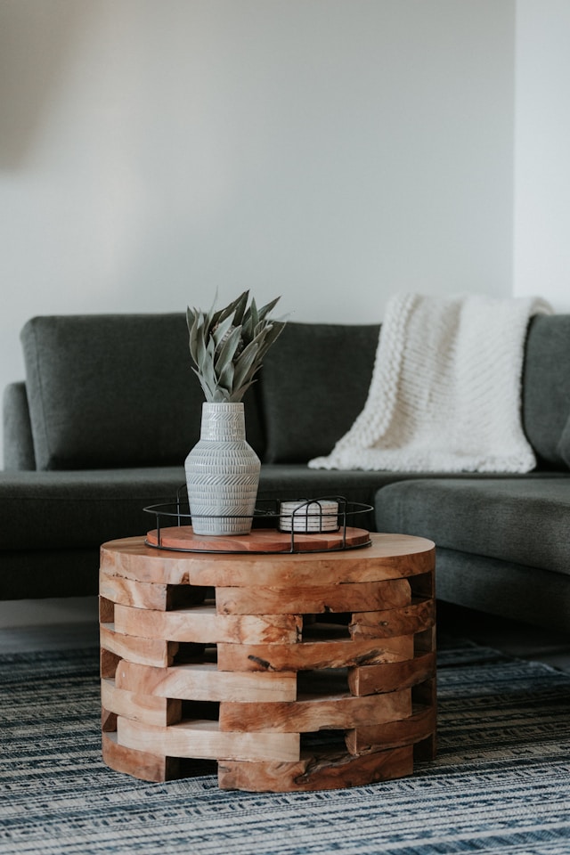 brown wooden coffee table next to the sofa