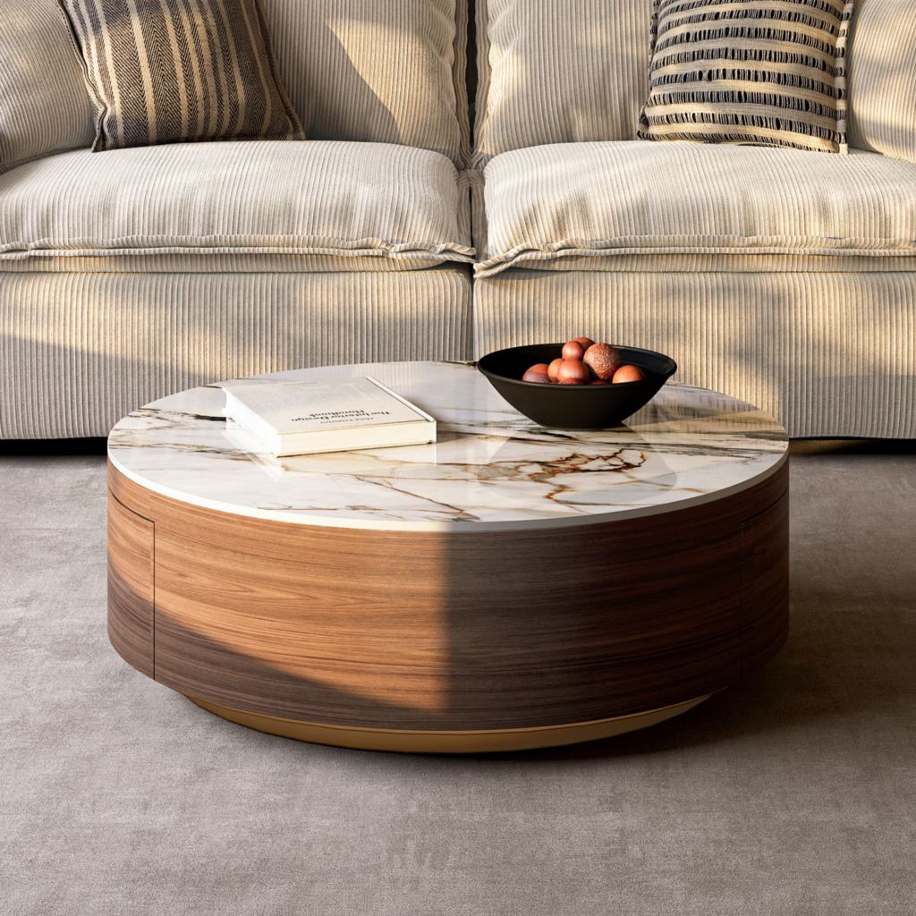 Round walnut drum coffee table with a marble-look top and hidden storage in front of a cream sofa.