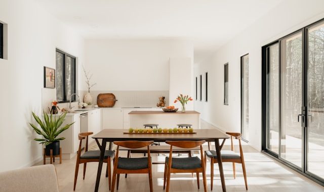 rectangular dining table in an open-plan kitchen and living room showing clear traffic flow around the table
